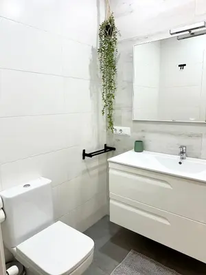 a white bathroom with a toilet and a sink at Casa Únic - Modern Central Home in Ruzafa in Valencia