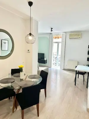 a living room with a dining table and chairs at Casa Únic - Modern Central Home in Ruzafa in Valencia