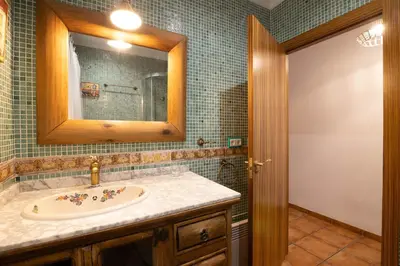 a bathroom with a sink and a mirror at Villa en Valencia, piscina privada y metro 500m in La Eliana