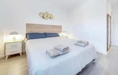 a bedroom with a white bed with two towels on it at Gorgeous Home In Riba-Roja De Turia in Riba-Roja De Turia