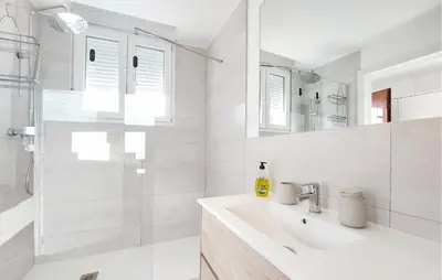 a white bathroom with a sink and a shower at Gorgeous Home In Riba-Roja De Turia in Riba-Roja De Turia