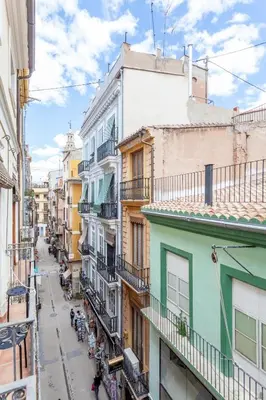 an alley in an old city with buildings at Sunny Modern Flat by Mercado Central in Valencia