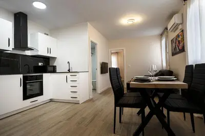 a kitchen and dining room with a table and chairs at PLAYA SUITES a 50 metros de la playa in Puerto de Sagunto