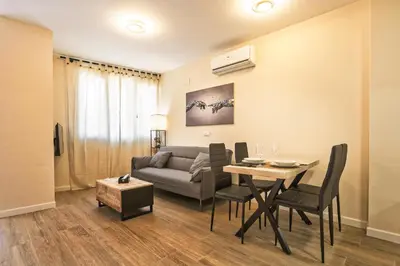 a living room with a table and a couch at PLAYA SUITES a 50 metros de la playa in Puerto de Sagunto
