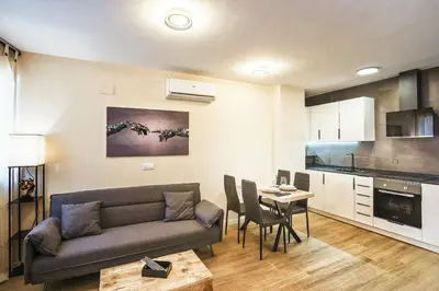 a living room with a couch and a table at PLAYA SUITES a 50 metros de la playa in Puerto de Sagunto