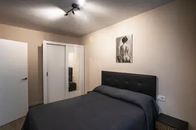 a bedroom with a bed and a ceiling fan at PLAYA SUITES a 50 metros de la playa in Puerto de Sagunto
