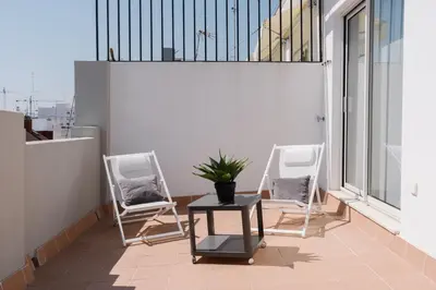 two chairs and a table on a balcony at Coliving La Alfareria in Valencia