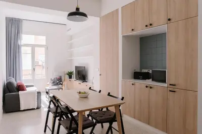 a kitchen and dining room with a table and chairs at Coliving La Alfareria in Valencia