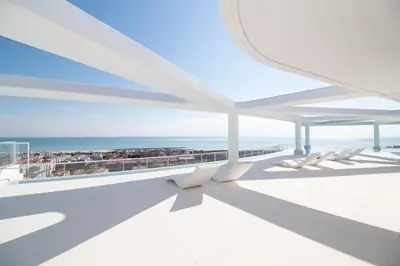 a view of the ocean from the balcony of a building at Global Vacacional, Nuevo apartamento con piscina privada y terraza con vistas al mar in Canet de Berenguer