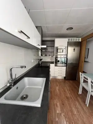 a kitchen with a large white sink in a room at Piso a 3 minutos de la playa!! 6 personas in Cullera