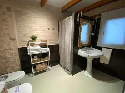 a bathroom with a sink and a mirror at Apartamentos Ca Federo, Casa la Tía Elena in Losa del Obispo