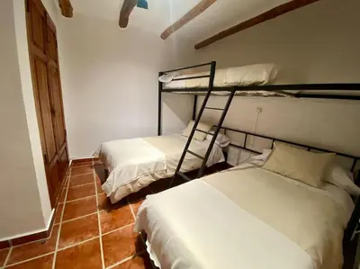a room with two bunk beds in a room at Apartamentos Ca Federo, Casa la Tía Elena in Losa del Obispo