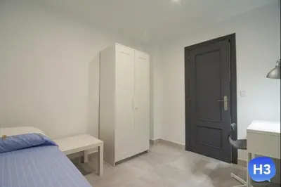 a bedroom with a bed and a closet and a door at Despuig Delight in Valencia
