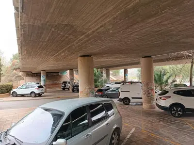a parking lot with cars parked under a bridge at loft Gilet 20 km Valencia montaña Senderismo Bici in Gilet