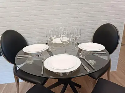 a glass table with empty plates and wine glasses at loft Gilet 20 km Valencia montaña Senderismo Bici in Gilet