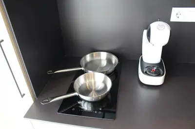a counter top with two pans and a blender at Promotur Suites - Ayora in Valencia