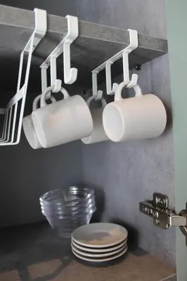 a kitchen with white mugs hanging from a shelf at Promotur Suites - Ayora in Valencia