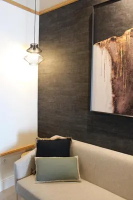 a couch in a living room with a painting on the wall at Promotur Suites - Ayora in Valencia