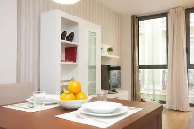 a dining room table with a bowl of fruit on it at SingularStays Comedias in Valencia