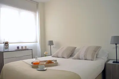 a bedroom with a bed with a tray of food on it at SingularStays Comedias in Valencia