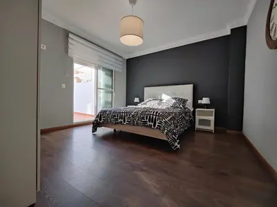 a bedroom with a zebra print bed and a large window at Casona Torrent in Torrent