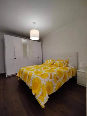 a bedroom with a yellow and white bed with pillows at Casona Torrent in Torrent