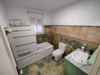 a bathroom with a tub and a toilet and a sink at Casona Torrent in Torrent