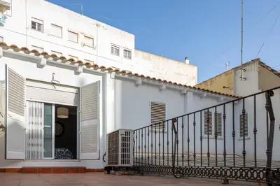 a white building with a gate and a balcony at Casona Torrent in Torrent