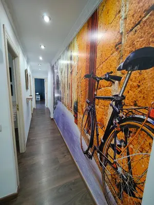 a bike parked against a wall in a hallway at Casona Torrent in Torrent