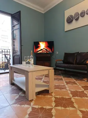 a living room with a table and a fireplace at Plaça de l'Almudí, where else! in Onda