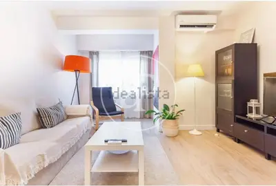 a living room with a couch and a table at Estación Central Family Home in Valencia
