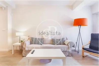 a living room with a couch and a table at Estación Central Family Home in Valencia
