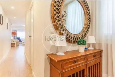 a mirror on top of a dresser in a hallway at Estación Central Family Home in Valencia