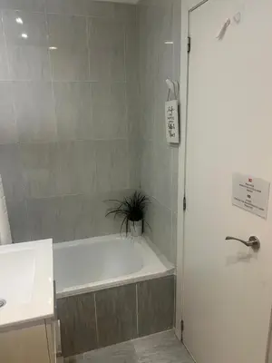 a bathroom with a bath tub and a sink at Estación Central Family Home in Valencia