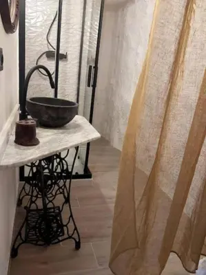 a bathroom with a stone sink on a table at La casita del Horno in Pedralba