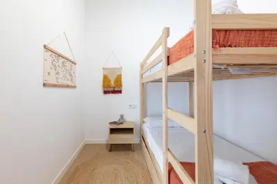 a bedroom with a bunk bed and a bunk room with a ladder at Travel Habitat Zaidia con Terraza in Valencia