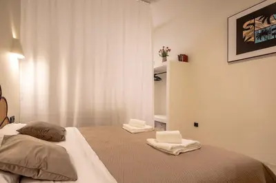 a bedroom with a bed with two towels on it at Suite de lujo estilo mediterráneo in Valencia