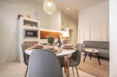 a living room with a table and a couch at Suite de lujo estilo mediterráneo in Valencia