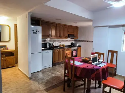 a kitchen with a table with a laptop on it at Valencia in Valencia