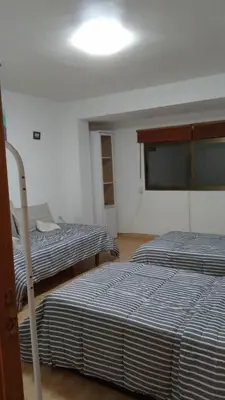 a room with two beds and a light on the ceiling at Valencia in Valencia