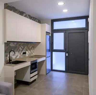 a kitchen with a sink and a black door at Céntrico 6 personas Ciencias Oceanografico in Valencia