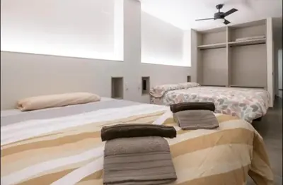 a bedroom with two beds with towels on them at Céntrico 6 personas Ciencias Oceanografico in Valencia