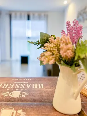a vase filled with flowers sitting on a table at Diyenn Burriana alojamiento y placer in Burriana