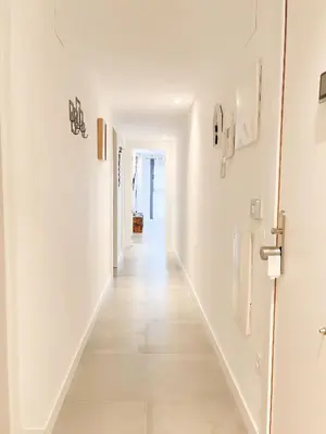 a hallway with white walls and a long white floor at Diyenn Burriana alojamiento y placer in Burriana