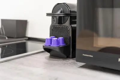 two purple bottles are sitting next to a microwave at VLC HOST - Bellvis in Valencia