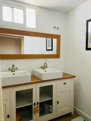 a bathroom with two sinks and a mirror at VILLA FALI in Benaguacil