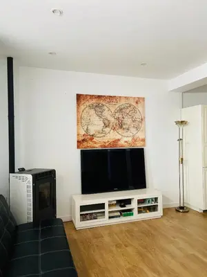 a living room with a flat screen tv on a wall at VILLA FALI in Benaguacil
