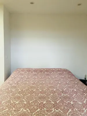 a bed in a room with a bedspread on it at VILLA FALI in Benaguacil