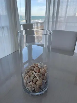 a glass vase filled with rocks sitting on a table at Apartamento con Vistas Panorámicas in Sueca