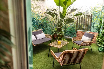 a patio with four chairs and a table and a plant at Artistic flat next to Ruzafa Welcome to the Jungle in Valencia